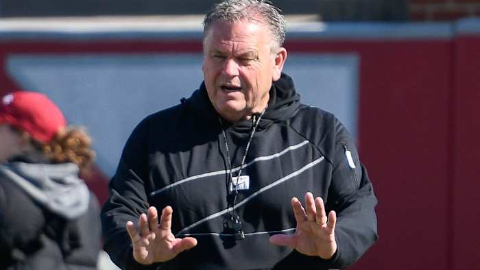 Arkansas coach Sam Pittman works with his players during spring practice in Fayetteville.
